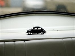 A model of a Volkswagen Beetle toy is seen inside a Volkswagen Beetle car at a...