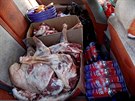 Sheep meat and cooking gas are seen in the back of a van on the road to the...