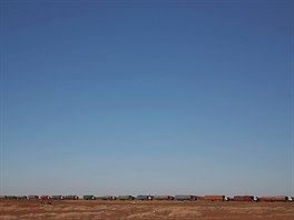 Thousands of heavy-duty trucks loaded with coal are lined up for up to 130...