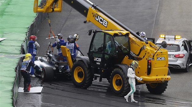 Lewis Hamilton z tmu Mercedes (vpravo) odchz od svho havarovanho vozu.