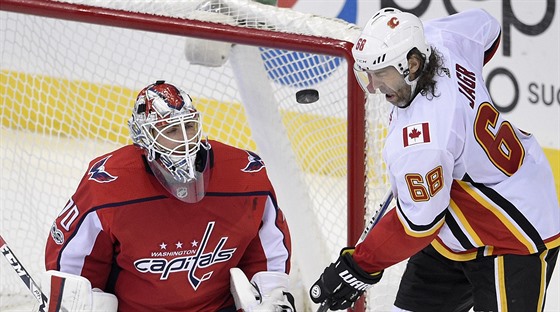 Jaromír Jágr z Calgary v anci ped washingtonským brankáem Bradenem Holtbym.