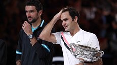 Roger Federer (vpravo) s trofejí pro vítze Autralian Open vedle poraeného...