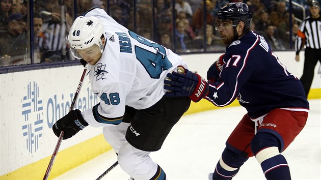 tonk San Jose Tom Hertl (vlevo) u puku, dotr na nj Brandon Dubinsky z Columbusu.