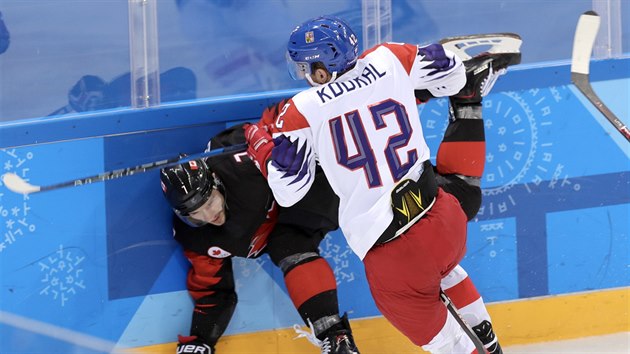 Petr Koukal atakuje u mantinelu jednoho z kanadských hokejistů. (17. února 2018)