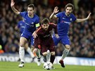 MEZI DVMA. Lionel Messi z Barcelony uniká Césaru Azpilicuetovi (vlevo) a Cescu...