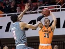 Oklahoma State Cowboys guard Jeffrey Carroll (30) three point basket defended...