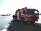 Bagr uvízl v bahně při čištění dna vodní nádrže Rozkoš na Náchodsku (1.3.2018).