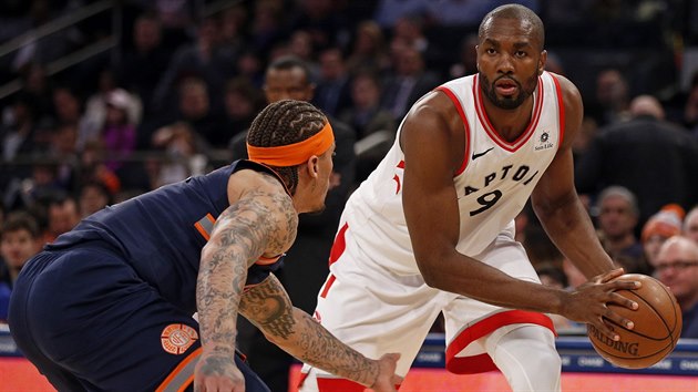 Serge Ibaka z Toronto Raptors dr m v zpase proti New York Knicks. Brn ho Michael Beasley.