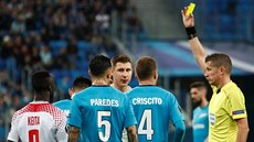 Fotbalista Lipska Willi Orban (uprost�ed) dostává �lutou kartu od rozhod�ího...