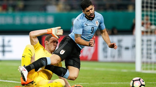 esk brank Ji Pavlenka fauluje uruguayskho tonka Luise Sureze v mezisttnm utkn na turnaji China Cup. Z nazen penalty Surez skroval.