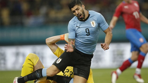Uruguayský útočník Luis Suárez padá po faulu českého brankáře Jiřího Pavlenky na China Cupu. Suárez z nařízené penalty skóroval.
