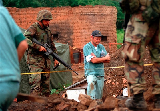 Forenzní technik nad masovým hrobem v Kosovu v roce 1999