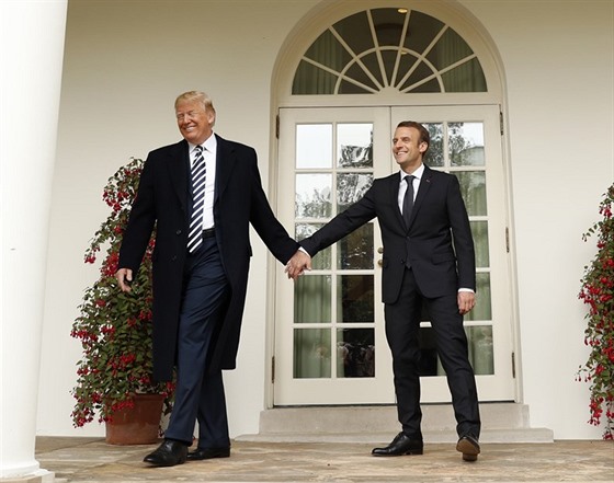 Americký prezident Donald Trump se vede za ruku se svým francouzským protjkem...