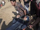 Palestinští demonstranti nesou zraněnou ženu (15. května 2018).