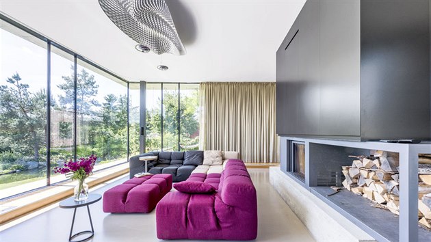 Litá podlaha ze stěrky Mapei v obývacím pokoji je zanořená hlouběji do země a kolem rámovaná navazující krytinou z třívrstvých dubových lamel, ukrývající konvektory.