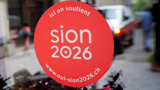 PODPORUJEME SION 2026. Nálepka na skle volební místnosti, kde Švýcaři v...