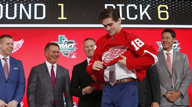 Filip Zadina oblk na draftu 2018 dres Detroitu, jeho zstupci v pozad z nadenm