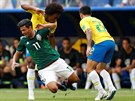 Mexický kídelník Carlos Vela padá po souboji s Willianem z Brazílie.