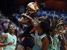 Connecticut Sun forward Chiney Ogwumike, center, is fouled by New York Liberty...