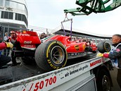 Odtahová služba odklízí havarovaný vůz Sebastiana Vettela z tratě Velké ceny...