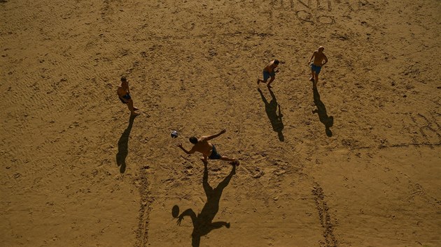 Lid hraj volejbal na pli La Concha ve panlsku, kter zachvtila vlna veder. (3. srpna 2018)