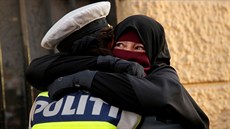 Muslimka Ayah se objímá s policistkou b�hem demonstrace proti zákazu zahalování...