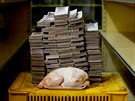 A 2.4 kg chicken is pictured next to 14,600,000 bolivars, its price and the...