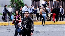 Lidé po zemtesení opoutjí úední budovu v Caracasu