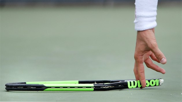 TROSKY.  Argentinsk tenista Guido Pella sbr zbytek sv rakety, kterou rozmltil ve tetm kole US Open.