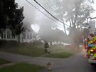Firefighters work near a building emitting smoke after explosions in North...