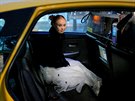 Model Madeline Stuart sits in the back of a taxi cab after walking in a runway...