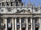 Tapestries portraying new proclaimed saints hang from the facade of St. Peter's...