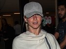 Julianne Hough keeps a low profile in poncho with Brooks Laich at LAX airport...
