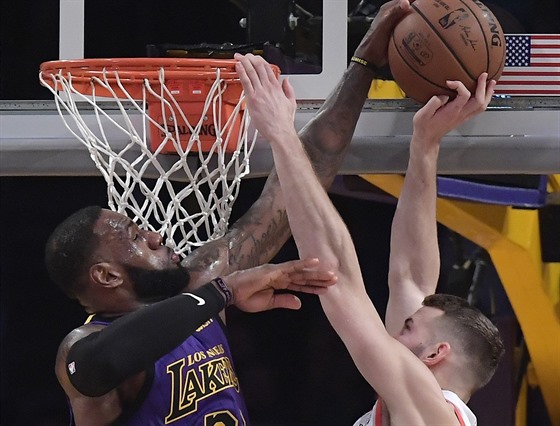 LeBron James (vlevo) z LA Lakers blokuje Nika Stauskase z Portlandu.