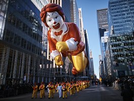 A Ronald McDonald balloon moves through Sixth Avenue during the...