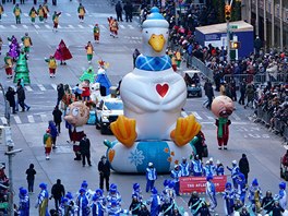 An Aflack Duck ballon is carried down 6th Avenue during the 92nd Macy's...