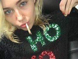 Zpvaka a rebelka Miley Cyrusová s vánoním svetrem a cigaretou marihuany