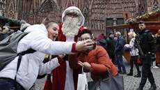 Lidé si dlají selfie se Santa Clausem na obnovených vánoních trzích ve...