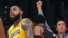 LeBron James (vlevo) z LA Lakers brán�ný Dwyanem Wadem z Miami hodn� nat�sno....