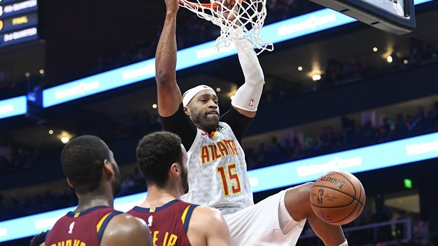 Vince Carter (15) z Atlanty smeuje do clevelandskho koe kolem Larryho Nance Jr. (uprosted) a Aleka Burkse.