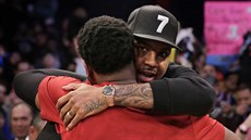 Dwyane Wade (zády) z Miami a Carmelo Anthony se zdraví v newyorské Madison...