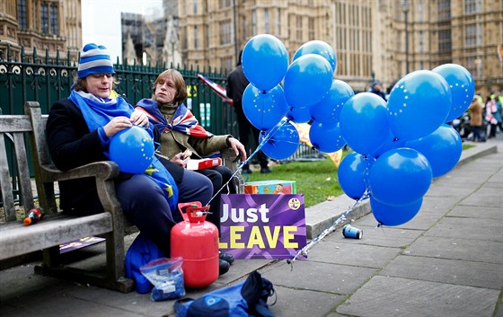 Na lavice ped parlamentem vedle sebe sedí odprkyn brexitu a jeho stoupenec,...