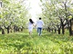 Young couple in love running in spring blossom garden