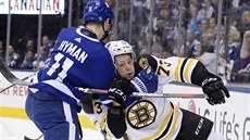 Zach Hyman (vlevo) z Toronta zastavuje Charlieho McAvoye z Bostonu.