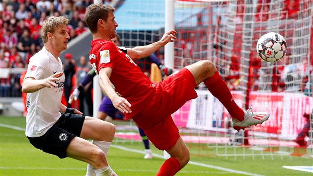 Thomas Müller z Bayernu Mnichov (vpravo) se snaží zpracovat míč s Martinem Hintereggerem z Frankfurtu na zádech.
