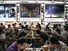 Huawei workers eat subsidized lunch in one of many large cafeterias at the...