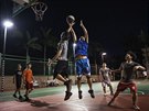 Huawei employees play basketball at a recreation area in staff housing at the...