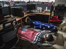 Huawei employees sleep at their cubicle during their lunch break, which is...