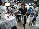 Huawei employees take part in an art class at a recreation area in staff...