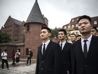 Huawei security guards line-up at the end of their workday at the new...
